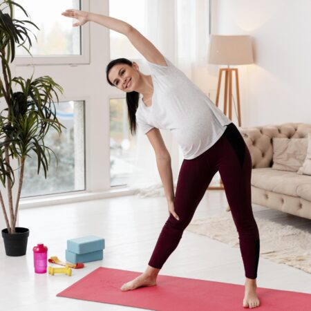 young-pregnant-woman-exercising-on-fitness-mat